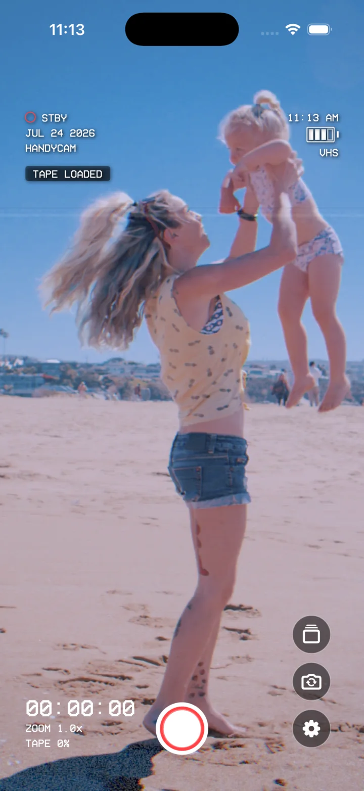 HomeMovieCam’s live VHS camcorder viewfinder recording a family at the beach.