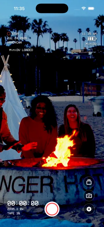 The same beach bonfire rendered with the MiniDV camcorder look.