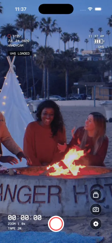 Beach bonfire rendered with the VHS camcorder look.