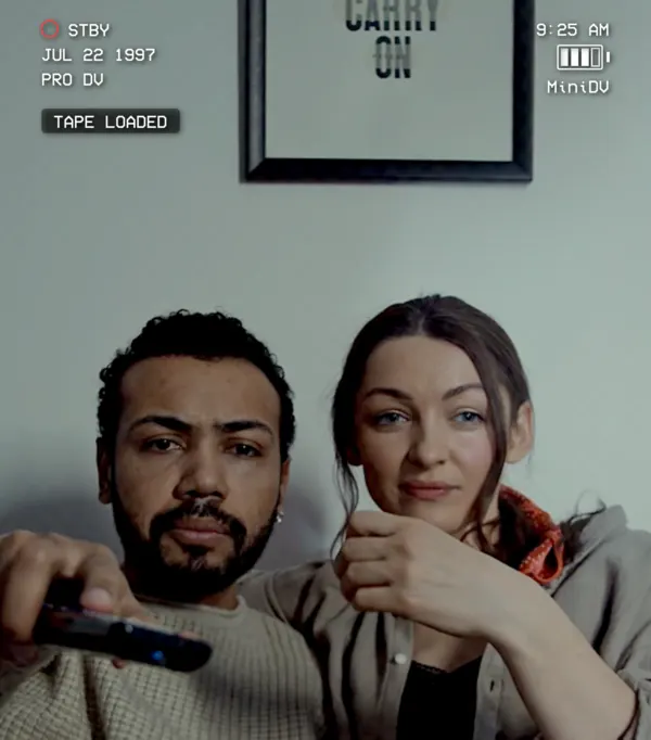 Professional DV camera recording a couple with popcorn in MiniDV.
